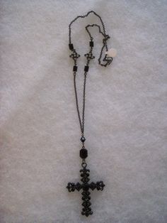 28" gunmetal goth cross with Jet bead and pewter/crystal accents. Cross measures 3"L x 2"W. Silver Cross Jewelry With Black Beads, Gothic Black Metal Cross Necklace, Gothic Beaded Cross Jewelry, Black Metal Crucifix Necklace, Black Metal Crucifix Cross Necklace, Gunmetal Cross Metal Jewelry, Black Metal Necklace With Antique Finish, Black Metal Crucifix Jewelry, Adjustable Metal Cross Necklace