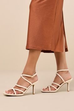 Making any look more glamorous is easy when you have the Lulus Skyy Beige Strappy High Heel Sandals! Smooth faux leather shapes these stunning heels that feature a trendy square footbed, crisscrossing toe straps, and a slender vamp strap (with elastic at the side for fit). Matching straps cross at the front and secure around the ankle with a gold buckle, all atop a stiletto heel. 3. 25" wrapped stiletto heel. Cushioned insole. Rubber sole has nonskid markings. Man made materials. Imported. Lulus | Skyy Beige Strappy High Heel Sandal Heels | Size 8.5. Strappy High Heels Sandals, Strappy High Heels, Size 11 Heels, High Heel Sandals, Stiletto Heels, Sandals Heels, Shoes Heels, High Heels, Faux Leather