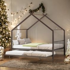 a bedroom with a bed and christmas tree in the corner