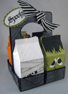 a halloween treat box with tissue paper and candy in the shape of a monster on it