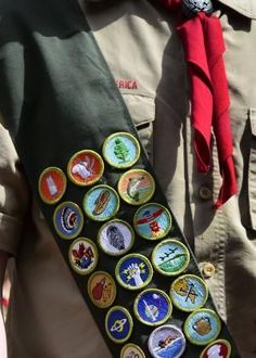 a close up of a person wearing a tie with badges on it