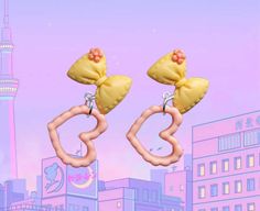 Embrace anime-inspired cuteness with these adorable bow earrings. Featuring an anime-inspired yellow bow and a dangling peach heart, these kawaii accessories are complemented by stud backings for a cute and stylish look. Express your love for anime aesthetics with these Anime-Inspired Bow Earrings - because great style is all about embracing cute and kawaii vibes! Kidcore Accessories, Earrings Kawaii, Yellow Bow, Kawaii Jewelry, Kawaii Accessories, Bow Earrings, Anime Inspired, Heart Earrings, Jewelry Earrings Studs