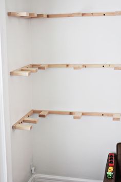 the shelves are made out of plywood and have wooden pegs to hold them