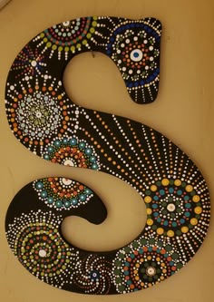 the letter s is decorated with colorful beads