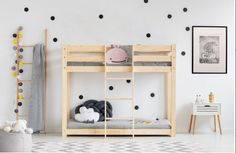 there is a bunk bed in the room with polka dot wall decals on the walls