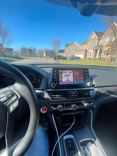 the interior of a car with an electronic device in the center and steering wheel view