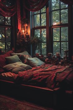 a bed sitting in front of two large windows