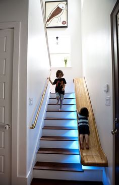 two young children are climbing up the stairs