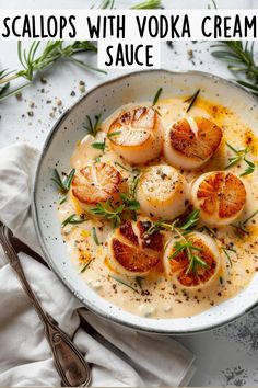 scallops with vodka cream sauce in a bowl on top of a white cloth