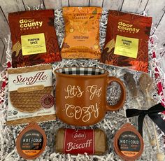 the coffee gift basket includes two mugs, cookies and other treats