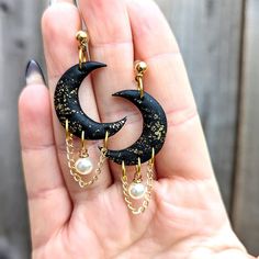 Gothic celestial crescent moon dangles with pearl and chain embellishment for the dark soul in you. The ideal witchy gift for yourself or another Goddess in your life. The main jewellery body is handcrafted from polymer clay, with gold-plated ball posts and chain. Lightweight and durable. If you have any questions, please do reach out and I will answer you ASAP. Mystic Clay Designs operates a no return/cancellation policy, due to the made to order nature of these products. However, if you do hav Kitchy Jewelry, Air Dry Clay With Crystals, Polymer Clay Jewelry With Crystals, Clay Goth Earrings, Homemade Clay Jewelry, Witch Aesthetic Jewelry, Polymer Clay Gothic Jewelry, Celestial Polymer Clay Earrings, Polymer Clay Moon Earrings