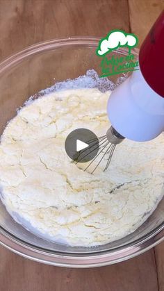 a mixing bowl with flour and an electric mixer