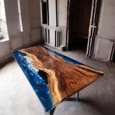 the table is made out of wood and has blue paint on it's surface