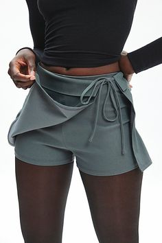 BDG skort in a wrap-front silhouette. Designed in a woven fabric with a touch of stretch featuring a mid-rise waistline, wrap-front overskirt with a tie detail at the waistline for a personalized fit. Find it only at Urban Outfitters. Features BDG Bengaline wrap tie-front micro skort Asymmetrical mini skort Stretch woven fabric Mid-rise waistline with tie detail Asymmetrical overskirt panel Shorts at the back Slim fit Mini length Adjustable tie detail Zip closure UO exclusive Content + Care 74% Brand Sale, Summer Clothes, Exclusive Collection, Find It, Woven Fabric, Workout Clothes, Womens Bottoms, Mid Rise, Urban Outfitters