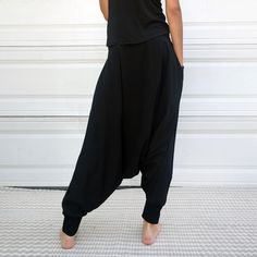 "Black Samurai Style Ninja Pants for Women and Men. This Stretch Cotton Harem Pants Fit Plus Size. -Unisex -Stretch -Flowing relaxed fit -Inner drawstring to secure the waist -2 side pockets Great for Yoga, Dance, Exercises, Meditations, Yoga Practice and beyond... Materials: black color cotton blend (90% cotton 10% lycra). Fabric for this pair were bought in Fashion District, LA and the pant was made in one of the studios in Los Angeles, CA. Measurements: Fits: S, M, M/L -Length: 41\" (~102 cm) Black High-waist Relaxed Fit Yoga Pants, Black High Waist Relaxed Fit Yoga Pants, Casual Harem Bottoms With Side Pockets, Baggy Cargo Pants For Loungewear, Black Stretch Harem Pants For Loungewear, Stretch Black Harem Pants For Loungewear, Black Yoga Bottoms With Hip Pockets, Black Harem Pants For Loungewear, Black Harem Pants For Loungewear With Loose Fit