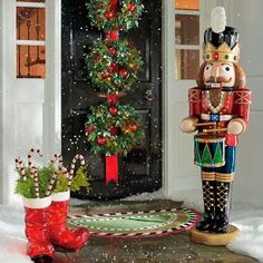 a nutcracker is standing in front of a christmas tree with decorations on it