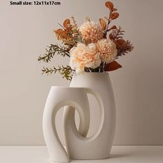 there is a vase with flowers in it on the white counter top, and an inscription that says small size 12x7cm