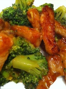 chicken and broccoli with sauce on a white plate