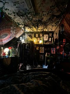 a bedroom with lots of plants and pictures on the wall, lights in the ceiling