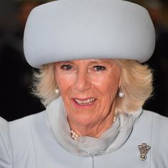 the queen of england is wearing a white hat