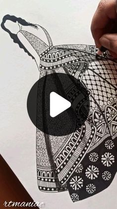 a person is drawing with black ink on white paper and has an image of a woman's head