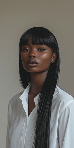 a woman with long black hair wearing a white shirt