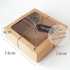 a brown box with a string tied around it and the measurements for each package in front of it