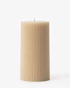 a white candle sitting on top of a table