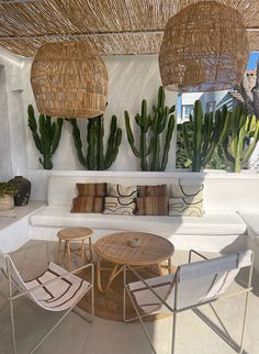 an outdoor living area with couches, tables and plants on the roof top terrace