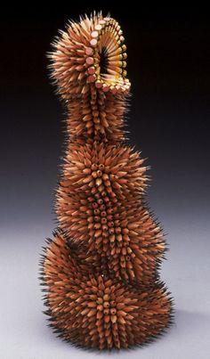 a sculpture made out of pencils sitting on top of a table