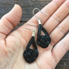 These lovely leather earrings feature a beautiful Celtic knot design. The nautical design of these leather dangle earrings makes them perfect for everyday wear or a night out on the town! Available in black or dark brown leather. Length: Hangs approximately 1 3/4" below the earlobe. Ear Wires: Hypoallergenic Surgical Steel Your earrings will arrive packaged in a kraft, recycled paper jewelry box tied with a raffia bow. You may also like: https://www.etsy.com/listing/235512056/silver-and-leather- Earrings Celtic, Celtic Knot Earrings, Diy Bangle Bracelets, Nautical Earrings, Leather Jewelry Diy, Leather Jewels, Wedding Studs, Celtic Knot Designs, Celtic Earrings