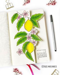 an open notebook with lemons and flowers on it