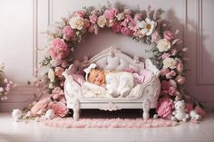 a baby is sleeping in a white bed surrounded by pink flowers