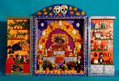 a colorful display case with skulls, flowers and other decorations on it's sides