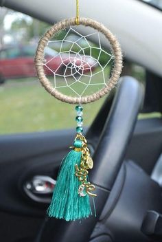 a car dashboard with a dream catcher hanging from it's side