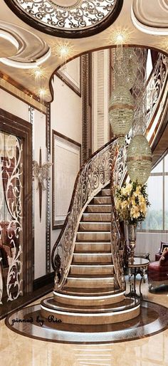 a large staircase in the middle of a living room with chandelier above it