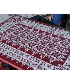 a red table with white designs on it