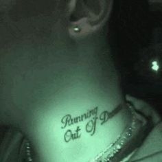 a woman with a tattoo on her stomach that says, running out of time in the dark