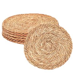 two round straw placemats sitting next to each other on a white background,