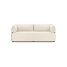 a white couch sitting on top of a wooden floor