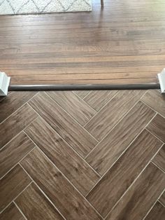 a wooden floor with two white handles on it