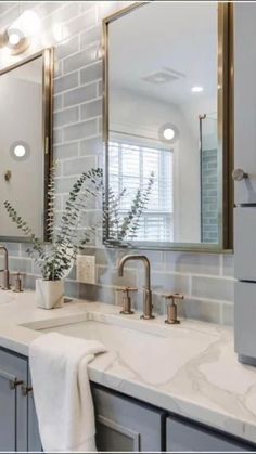 a bathroom with two sinks and mirrors in it