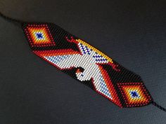 a beaded bracelet with an image of a bird on it's back end