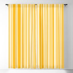 yellow and white striped curtains hanging on a wall