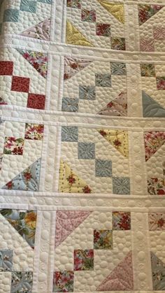 a close up of a quilt on a bed