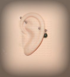 a pair of ear piercings are shown in this artistic photo with the word love written on it