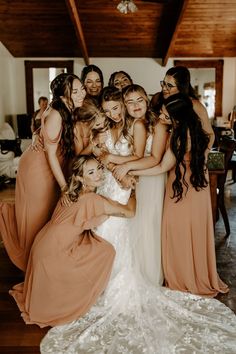 a group of bridesmaids hugging each other