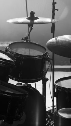 a black and white photo of drums on stage