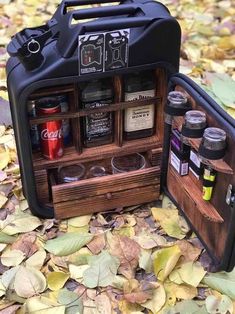 an open case filled with spices and condiments on top of leaf covered ground