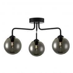 three lights are hanging from the ceiling with black metal fittings and round glass shades